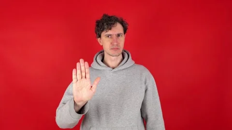Man raises hand, palm forward, showing in front sign stop, ban gesture. 库存影片 304749237