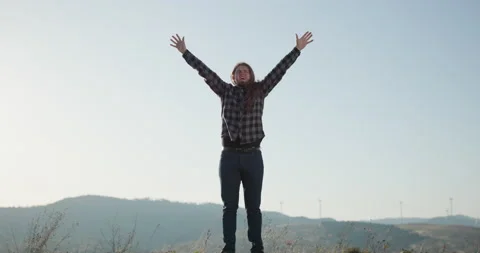 Man raises hands up standing on mountain top sunset. Success and achievement - Stock Footage 195245990