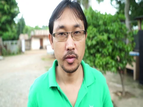 Man raises plate of fried crickets to face (rack focus) Stock Footage 74853845