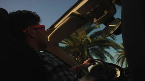 Man raises their hands in delight in the air against the background of palm Stock Footage 231578852