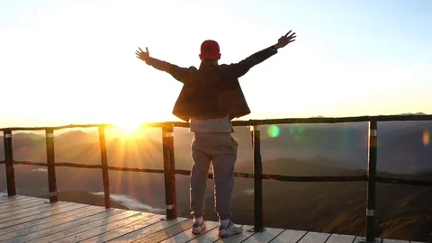 A man raising arms in sunset. Stock Footage 71569054