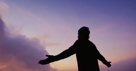 Man Raising Arms at Sunset Stock Footage 82218617