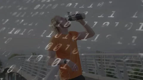 Man raising bottle, drinking on bridge, checking lid and time, adjusting buds, Stock Footage 333670794