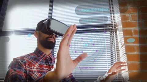 Man raising right hand toward blinds, using VR and editing holographic embedding Stock Footage 333145093