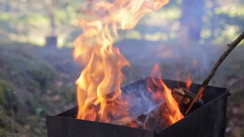 Man rake the coals in the brazier Stock Footage 71215544