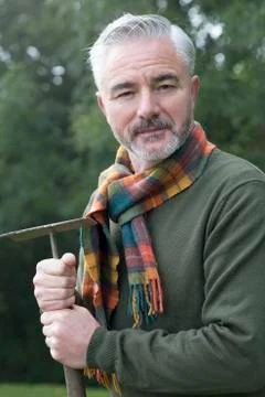 Man with rake looking at camera Stock Photos