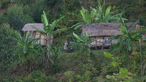 A man in Ranomafana using his mortar, Madagascar in 4K Stock Footage 107335646