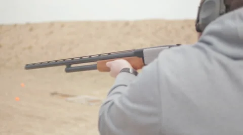 Man Rapidly Pumps and Fires Shotgun Stock Footage 60706357