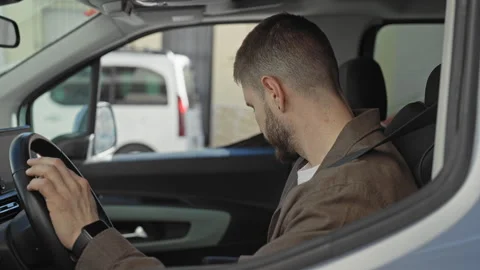 Man reaches to adjust rearview mirror with hand while wearing seatbelt in c.. Stock Footage 337366018