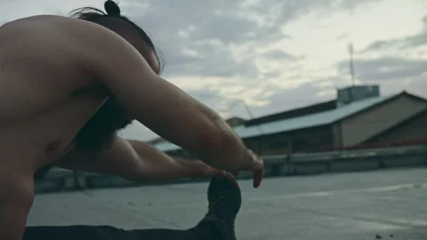 Man reaches forward to stretch leg Stock Footage 275594160