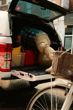 Man Reaching into the Back of a White Pickup Truck in Chiswick, London Stock Photos