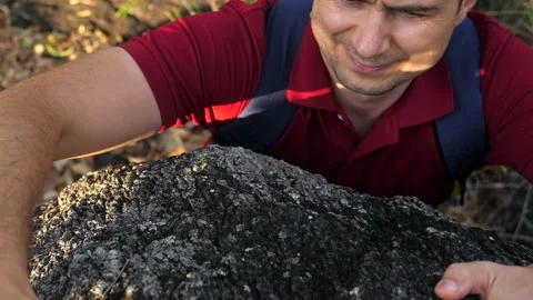 Man reaching for a grip while he rock climbs on a steep cliff. Young man Stock-Footage 196000592