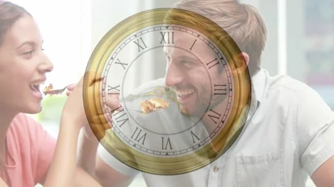 Man reaching to plate and starting feeding swap with woman, food clock overlay Stock Footage 328224768