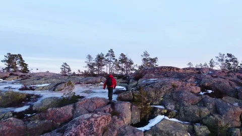 Man reaching the top of the rock in winter landscape Stock Footage 105856936
