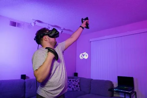 Man reaching toward virtual object in VR environment Stock Photos