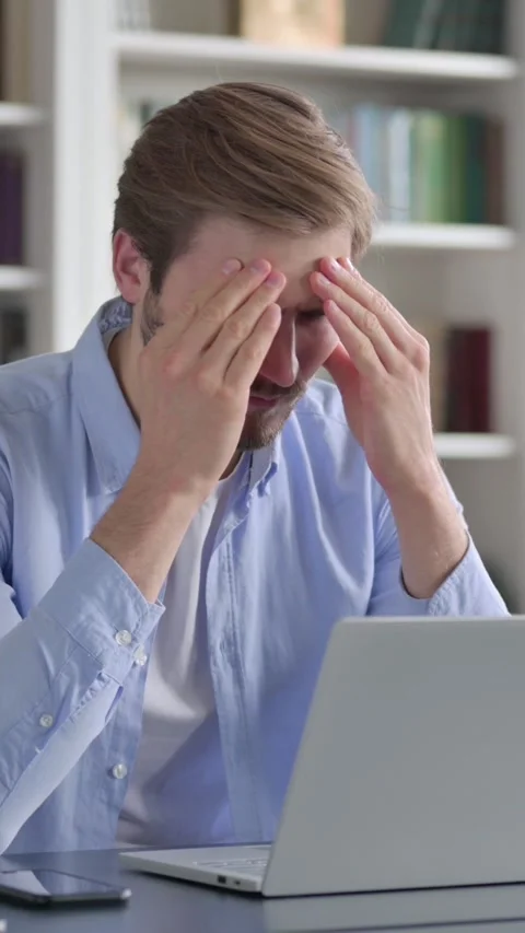 Man Reacting to Loss While using Laptop in Office, Vertical Video Stock Footage 339577923