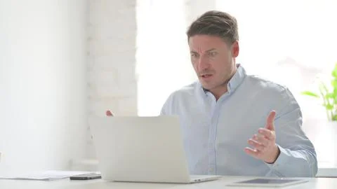 Man Reacting to Loss While using Laptop Stock Photos