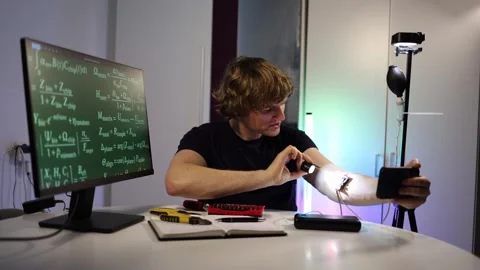 Man reacting to a small electric shock from a glowing bio chip experiment Stock Footage 323271115