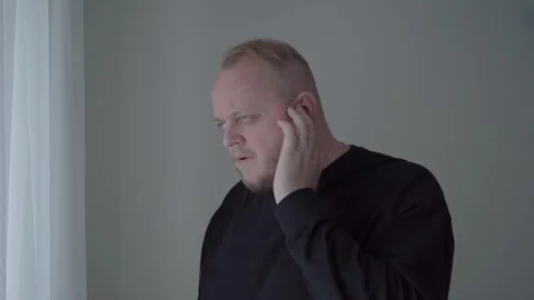 Man Reacting to Sudden Ringing in Ear and Tinnitus Symptoms Stock Footage 343719177
