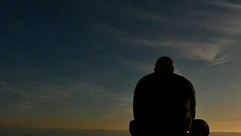 Man read book in meditation posture back view panoramic silhouette Stock Footage 89513749