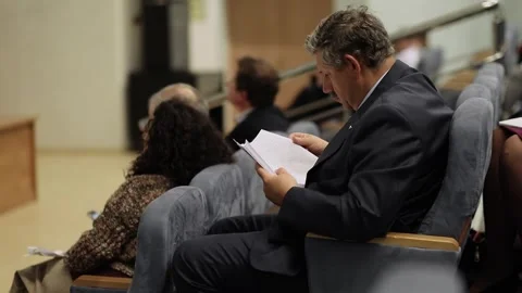 Man read documents during conference Surgical Stock Footage 299678998