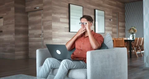 Man read shocking information on laptop. Stunned man takes off glasses in Stock Footage 271071534