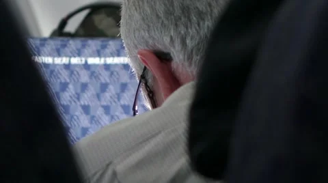 Man Reading on Airplane Stock Footage 41865484