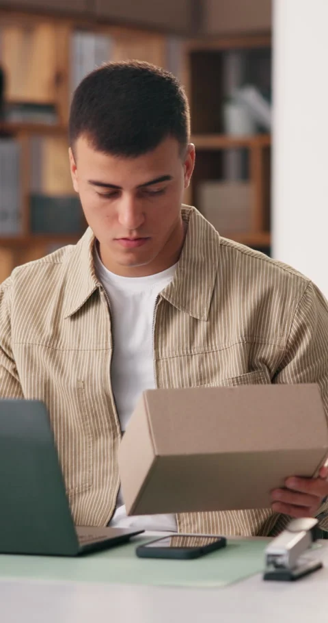 Man, reading and boxes with laptop in office for logistics, supply chain and Stock Footage 334315157