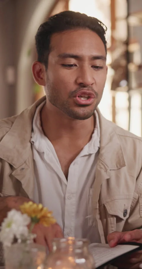 Man, reading and date with menu in restaurant for food choice, decision or Stock Footage 340633824