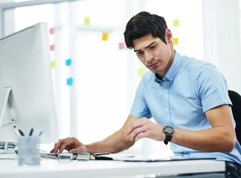 Man, reading and notebook in office with computer, journalist website or news Stock Photos