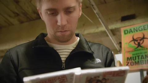 Man Reading Back of CD Cases in Flea Market Stock Footage 104690362