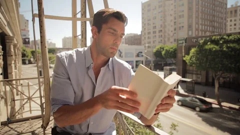Man reading on balcony 02 스톡 동영상 76734878