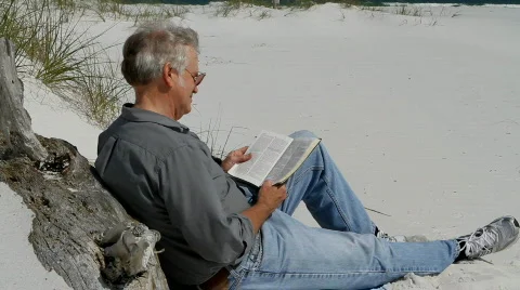 Man Reading Bible At Beach Stock Footage 709663