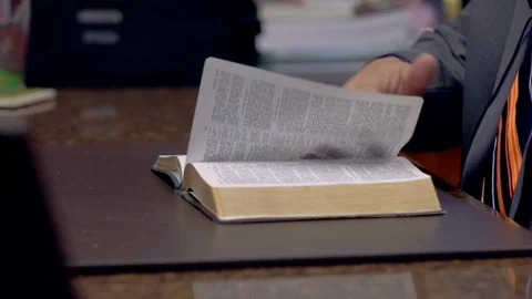 MAN READING BIBLE AT DESK 스톡 동영상 108328148