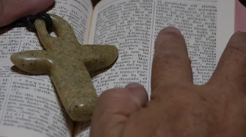 Man reading Bible scriptures in Latin Bible. Close-up Stock Footage 61455324