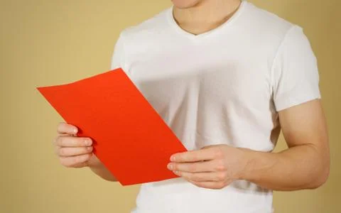 Man reading blank red A4 paper. Read detailed booklet. Leaflet presentation.. Stock-Fotos