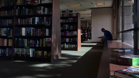 Man Reading A Book At Bookstore Stock Footage 94138717