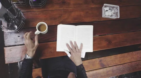 Man reading a book in cafe Stock Footage 63464676