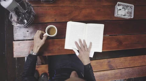 Man reading a book in cafe Stock Footage 63464683