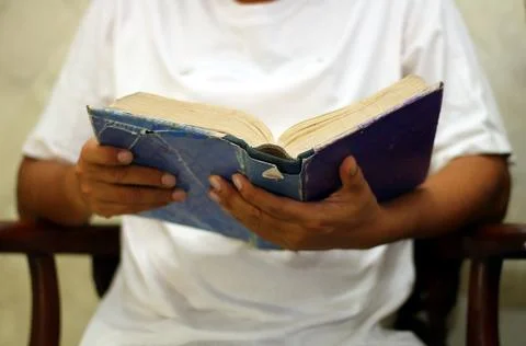 Man reading book in close up Stock Photos