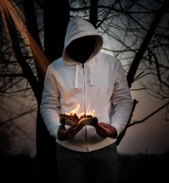 Man reading a book on fire. Stock Photos