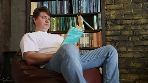 Man reading a book Stock Footage 76947825
