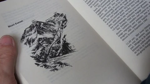Man Reading Book In A Foreign Language, Climbing Mount Everest, Close Up Stock Footage 119216763
