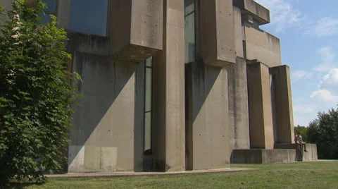 Man reading a book in front of concrete church (Wotruba-Kirche, Vienna) Stock Footage 56769310