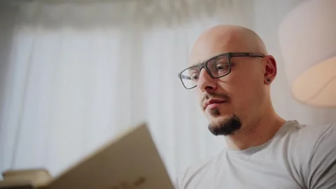 Man Reading a Book with Glasses Stock Footage 297991636