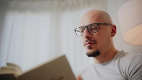 Man Reading a Book with Glasses Stock Footage 297991681