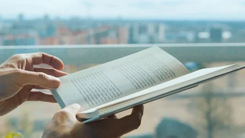 Man reading a book, hand turning pages Stock Footage 104816389