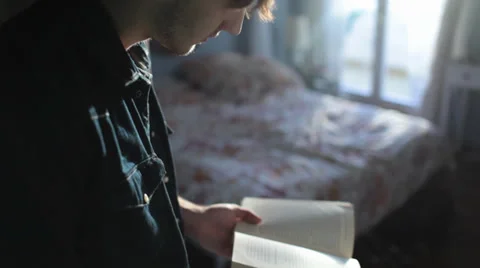Man reading a book at home Stock Footage 34164616