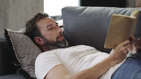 A man reading a book at home Stock Footage 142600208