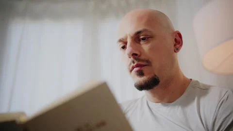 Man Reading a Book at Home Stock Footage 297991403